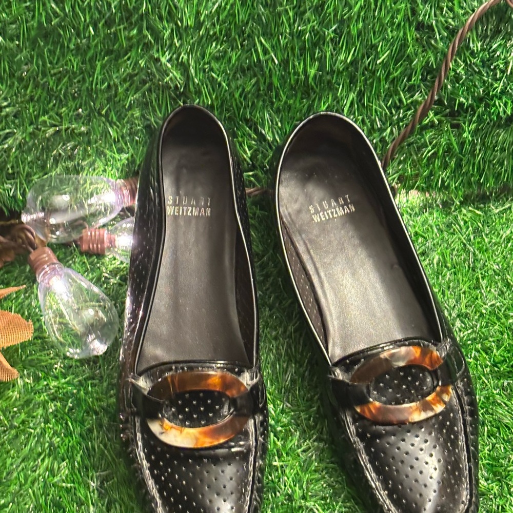 Stuart Weitzman Black Flats with Classic Loafer Design and Gold Ornament